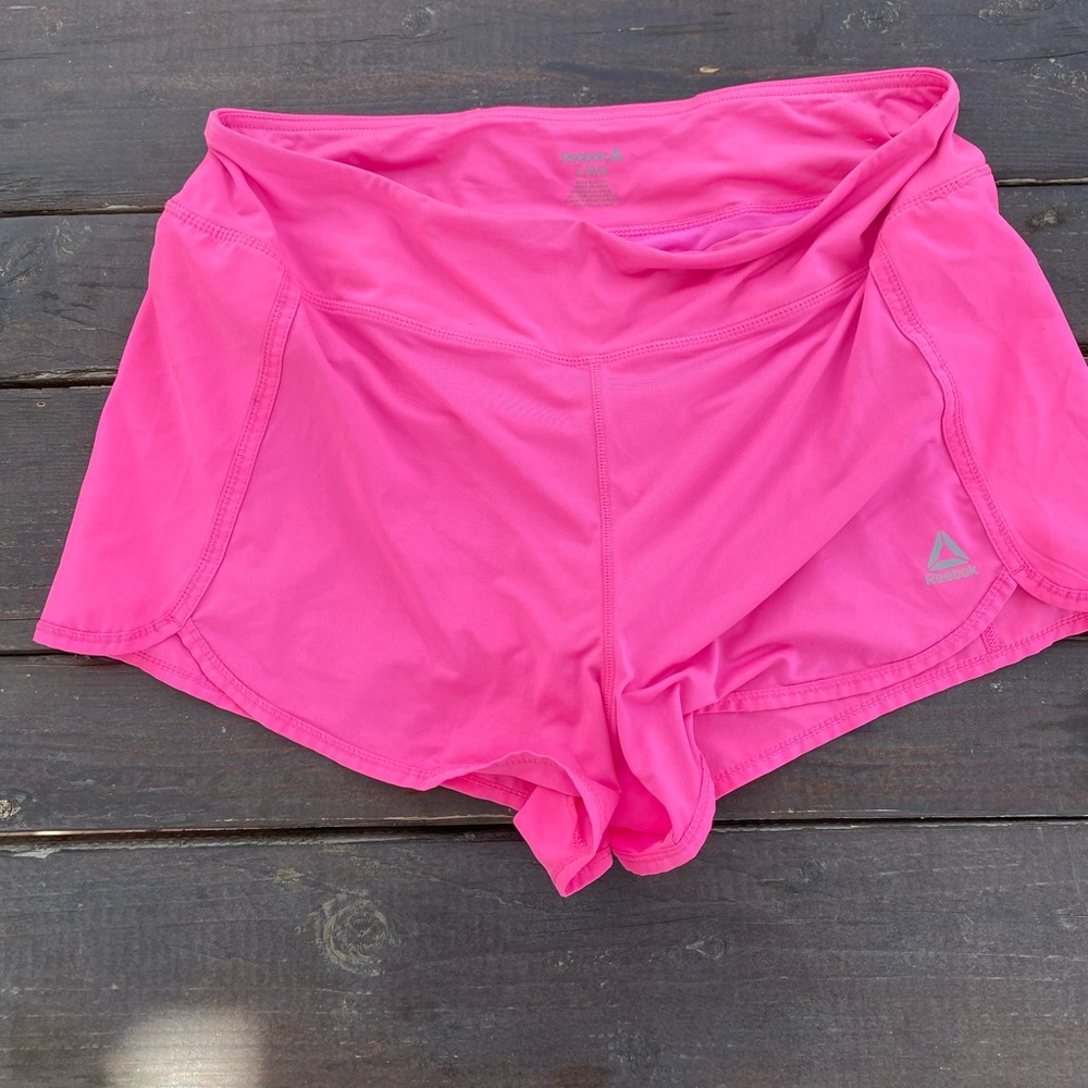 Bright pink Reebok running shorts